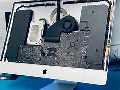 Image of a technician repairing an iMac
